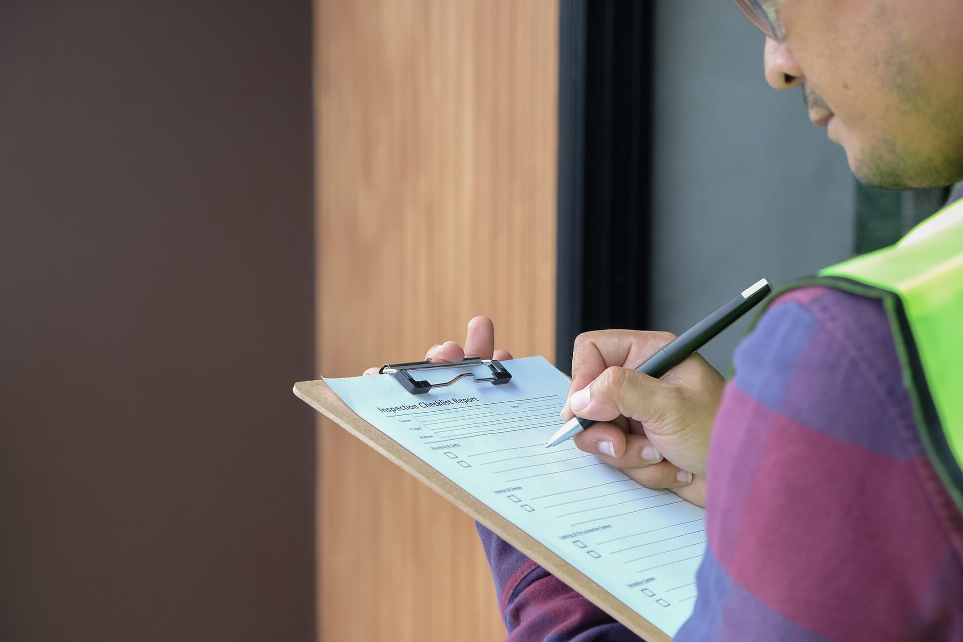 An employee fills out paperwork on a clipboard