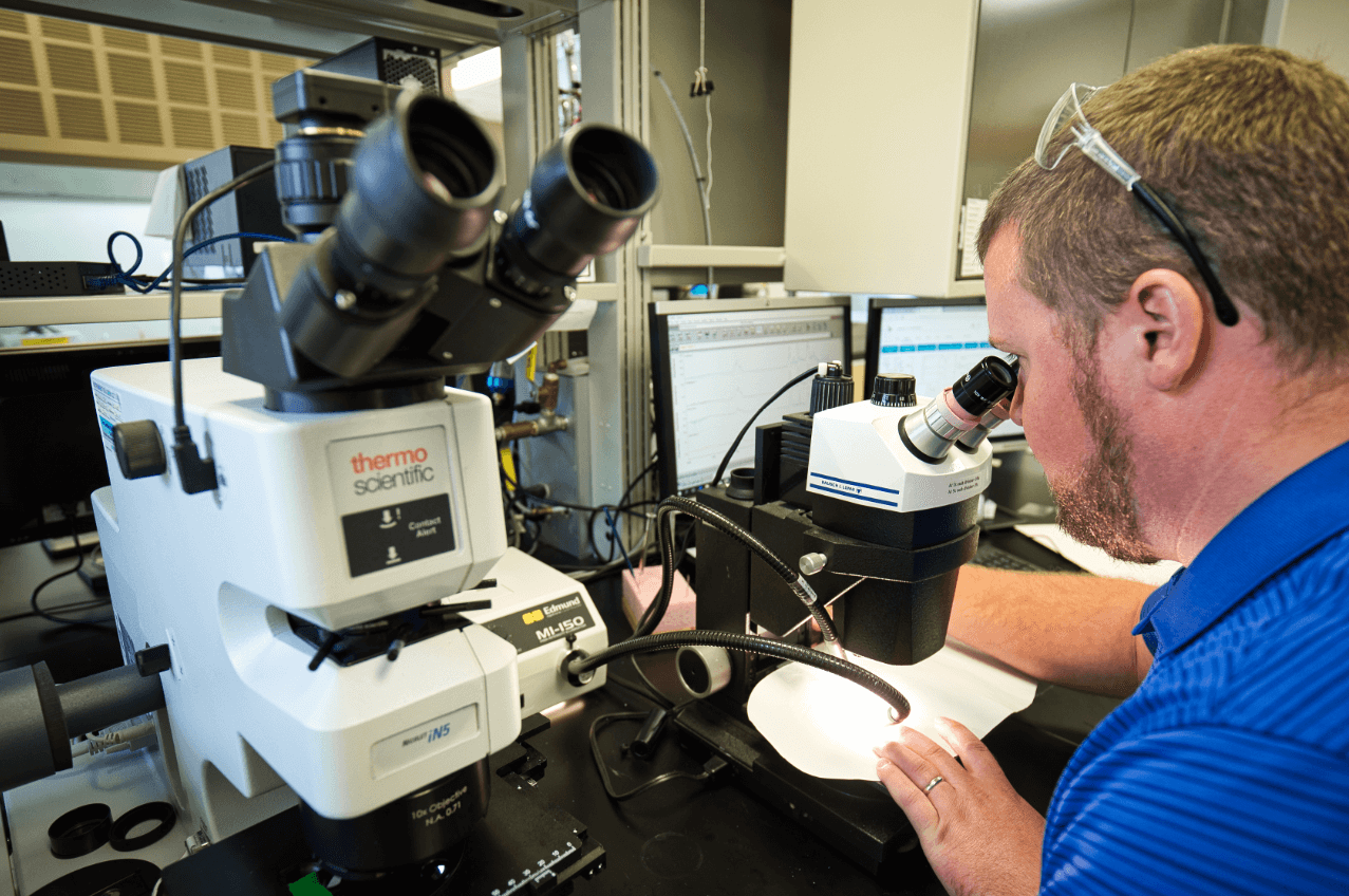 An Appvion chemist uses a microscope